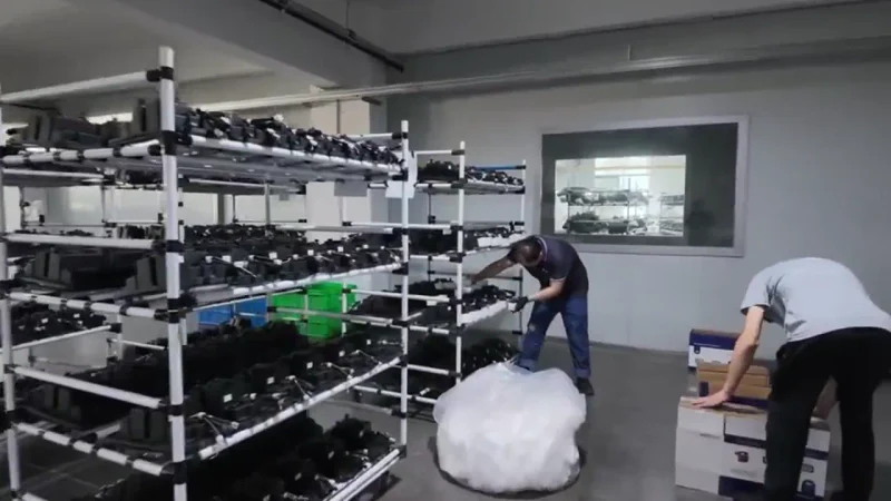 Parts being handled and packed into cartons.